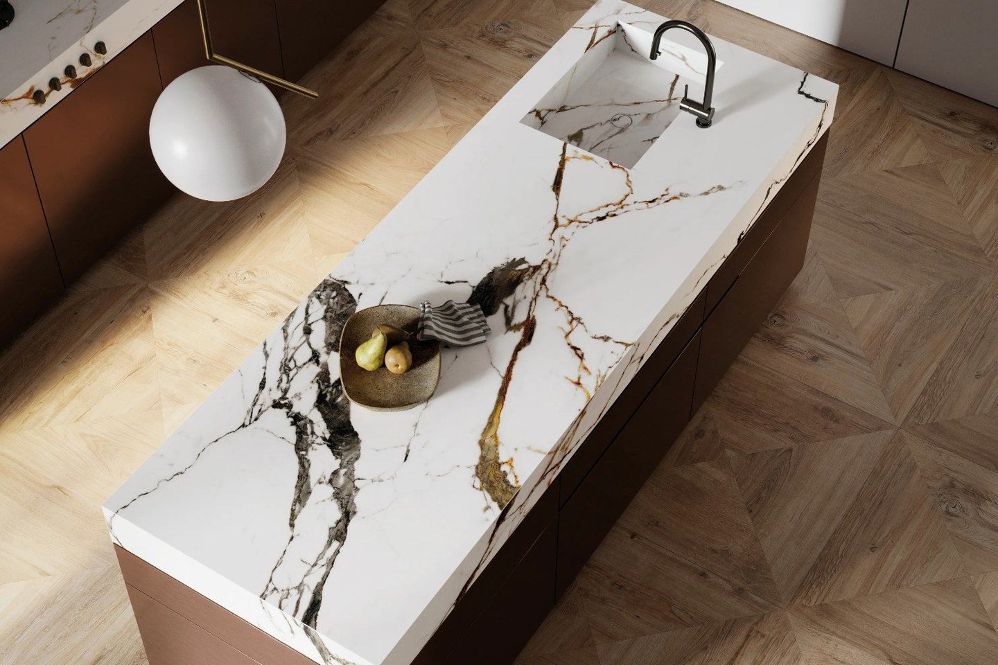 Kitchen island with a white marble-look top with dark and gold veins, seen from above