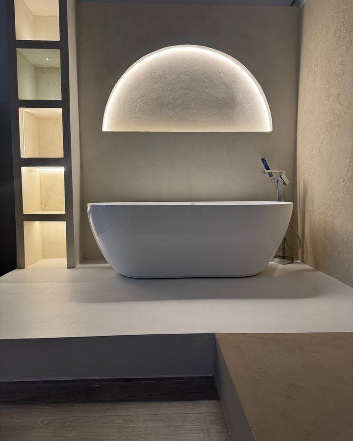 Microcement bathroom display with a freestanding tub in our Sarasota showroom
