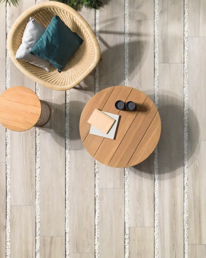 Wood-look pavers on a patio with chairs and small tables, seen from above